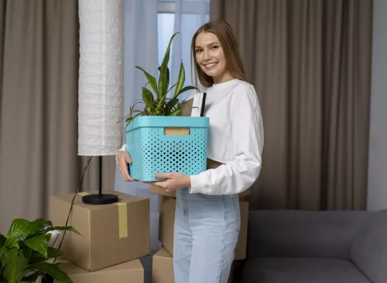 happy woman holding plant